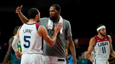 United States's Kevin Durant (7), center, celebrates with teammate Zachary Lavine (5) after their win in the men's basketball semifinal game against Australia at the 2020 Summer Olympics. (AP) United States's Kevin Durant (7), center, celebrates with teammate Zachary Lavine (5) after their win in the men's basketball semifinal game against Australia at the 2020 Summer Olympics. (AP)