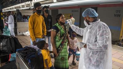 A healthcare worker collects swab samples for Covid-19 test of the passengers arriving from outstation trains at Dadar station, in Mumbai on Wednesday, August 4. (Pratik Chorge/HT photo) A healthcare worker collects swab samples for Covid-19 test of the passengers arriving from outstation trains at Dadar station, in Mumbai on Wednesday, August 4. (Pratik Chorge/HT photo)