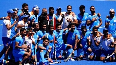 Members of the India team pose for photographs after defeating Germany 5-4 during the men's field hockey bronze medal match. (AP)