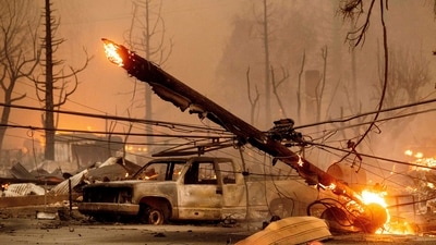 A utility pole burns as the Dixie Fire tears through the Greenville community of Plumas County, California. (AP) A utility pole burns as the Dixie Fire tears through the Greenville community of Plumas County, California. (AP)