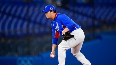 South Korea pitcher Sangwoo Cho looks for a sign during a semi-final baseball game against the United States at the 2020 Summer Olympics, Thursday, Aug. 5, 2021, in Yokohama, Japan. (AP Photo/Sue Ogrocki) (AP) South Korea pitcher Sangwoo Cho looks for a sign during a semi-final baseball game against the United States at the 2020 Summer Olympics, Thursday, Aug. 5, 2021, in Yokohama, Japan. (AP Photo/Sue Ogrocki) (AP)