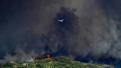 A Russian aircraft operates during a wildfire near ancient Olympia on August 4.  (AP)