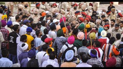 Police stand guard following a clash with agitators near the residence of Punjab CM Amarinder Singh in Patiala on Thursday.