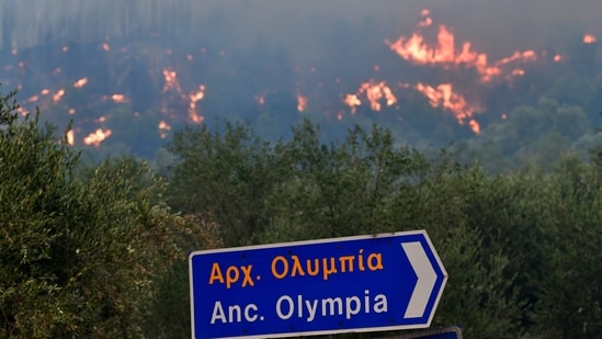 Greek authorities ordered more evacuations on an island near Athens and battled a blaze near the site of the ancient Olympic Games in the western Peloponnese as wildfires burned for the third day.(AP)