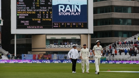 England's Jonny Bairstow and Stuart Broad walk off with an umpire after play restarted following a rain delay only to be stopped again after one ball was delivered(Action Images via Reuters)