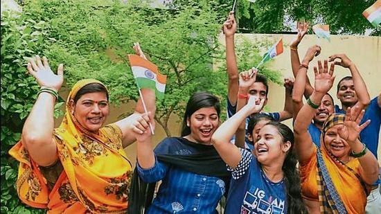 Delighted kin of hockey star Lalit Upadhyay celebrate in Varanasi on Thursday after India won the bronze medal at the Tokyo Olympics. (HT Photo)