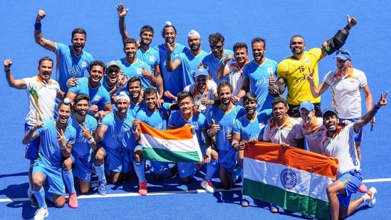 Indian players pose for photographs as they celebrate their victory over Germany in the men's field hockey bronze medal match, at the 2020 Tokyo Olympics(PTI)