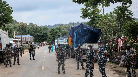 CRPF personnel stand guard at the national highway in Lailapur area near Assam-Mizoram border. (AFP)