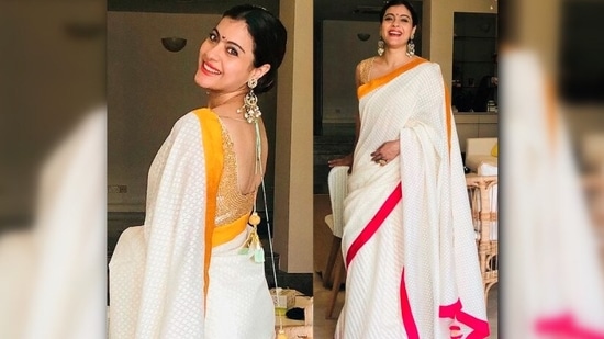 Kajol looks to-die-for in this white saree with a pink and yellow border. She paired it with an embellished golden blouse and big earrings.(Instagram/@kajol)