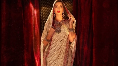 Nora accessorised her look with Apala by Sumit and Anmol brand's contemporary edge jewellery that sported exquisite designs and included a thick golden oxidised necklace which was encrusted white and green stones in a floral pattern, a pair of long matching golden jhumkas, silver hand cuffs, finger rings and a pretty red bindi on her forehead.  (Instagram/manekaharisinghani)