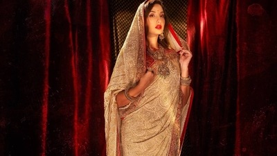 Nora's heavy chikankari saree came with embroidery work all over in ivory with zardozi. A red border with golden embroidery work on it ran along the saree's pallu to seal the traditional Awadh highlight. (Instagram/manekaharisinghani)