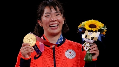 Gold medalist Japan's Risako Kawai poses with her medal on the podium after the women's freestyle 57kg wrestling competition of the Tokyo 2020 Olympic Games at the Makuhari Messe in Tokyo on August 5, 2021. (Photo by Jack GUEZ / AFP) (AFP) Gold medalist Japan's Risako Kawai poses with her medal on the podium after the women's freestyle 57kg wrestling competition of the Tokyo 2020 Olympic Games at the Makuhari Messe in Tokyo on August 5, 2021. (Photo by Jack GUEZ / AFP) (AFP)
