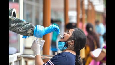 A woman gives swab sample for COVID-19 test at RML hospital in Lucknow, (PTI file photo)