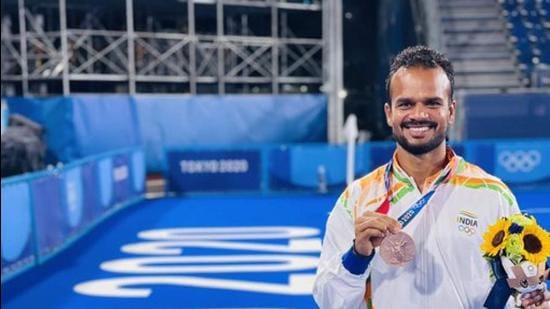 Lalit Kumar Upadhyay from Uttar Pradesh poses with the bronze medal that he won as a member of the Indian men’s hockey team at the Tokyo Olympics. (TWITTER IMAGE)