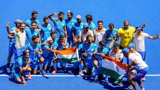 Indian players pose for group photographs as they celebrate their victory over Germany in the men's field hockey bronze medal match, at the 2020 Summer Olympics.(PTI)