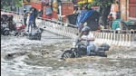 Commuters wade through a waterlogged Rohtak Road stretch near Anand Parbat on Saturday. IMD has predicted more rain on Sunday. (Sanchit Khanna/HT) Commuters wade through a waterlogged Rohtak Road stretch near Anand Parbat on Saturday. IMD has predicted more rain on Sunday. (Sanchit Khanna/HT)