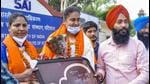 Kamalpreet being felicitated. The district sports department organised a special function outside the NIS campus in Patiala, where Kamalpreet, accompanied by her coach, had come to meet young athletes. (PTI) Kamalpreet being felicitated. The district sports department organised a special function outside the NIS campus in Patiala, where Kamalpreet, accompanied by her coach, had come to meet young athletes. (PTI)