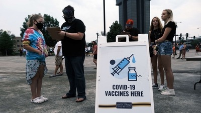 People wait to get vaccinated for Covid-19 at a baseball game on August 05, 2021, in Springfield, Missouri. (AFP)