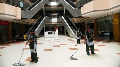 Workers cleaning the premises of P&amp;M Mall in Patna ahead of its reopening. (Santosh Kumar / HT PHOTO)