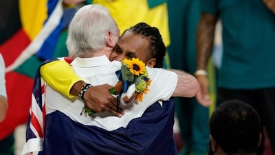 Australia's Patty Mills (5) hugs U.S. coach Gregg Popovich during the medal ceremony for basketball game at the 2020 Summer Olympics, Saturday, Aug. 7, 2021, in Tokyo, Japan. (AP Photo/Charlie Neibergall) (AP) Australia's Patty Mills (5) hugs U.S. coach Gregg Popovich during the medal ceremony for basketball game at the 2020 Summer Olympics, Saturday, Aug. 7, 2021, in Tokyo, Japan. (AP Photo/Charlie Neibergall) (AP)