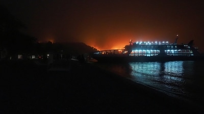 A ferry approaches Kochyli beach to evacuate people near Limni village on August 6.  (AP Photo/Thodoris Nikolaou)