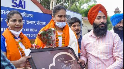Kamalpreet being felicitated. The district sports department organised a special function outside the NIS campus in Patiala, where Kamalpreet, accompanied by her coach, had come to meet young athletes. (PTI)