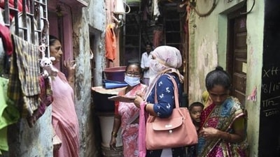 Experts fear that the undiagnosed cases of TB could facilitate the spread of the infection, but wearing of masks by a majority of the population might have an unintended but pleasant impact. In picture - A health department worker interacts with residents during a door to door survey for tuberculosis and leprosy in Mumbai. (PTI)