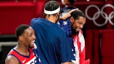 United States' Kevin Durant (7), right, celebrates with teammates after their win in the men's basketball gold medal game against France at the 2020 Summer Olympics, Saturday, Aug. 7, 2021, in Saitama, Japan. (AP Photo/Luca Bruno) (AP) United States' Kevin Durant (7), right, celebrates with teammates after their win in the men's basketball gold medal game against France at the 2020 Summer Olympics, Saturday, Aug. 7, 2021, in Saitama, Japan. (AP Photo/Luca Bruno) (AP)