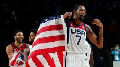 United States' Kevin Durant waves a United States flag as he celebrates with teammates after their win over France in a men's basketball Gold medal game at the 2020 Tokyo Olympics (AP) United States' Kevin Durant waves a United States flag as he celebrates with teammates after their win over France in a men's basketball Gold medal game at the 2020 Tokyo Olympics (AP)