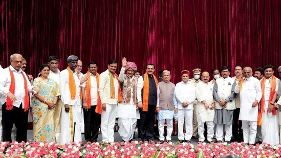 Karnataka governor Thawar Chand Gehlot and chief minister Basavaraj Bommai with newly inducted ministers during swearing-in ceremony to form the cabinet at Raj Bhavan in Bengaluru. (PTI)