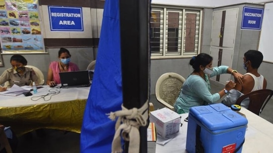 A health worker administers a dose of Covid-19 vaccine to a beneficiary, at a government school at DDU Marg in New Delhi. (Raj K Raj/HT file photo)