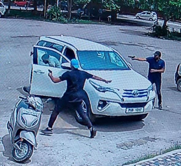A CCTV grab of the two assailants firing at Vicky Middukhera in the parking of a market in Sector 71, Mohali, on Saturday morning. (HT Photo) A CCTV grab of the two assailants firing at Vicky Middukhera in the parking of a market in Sector 71, Mohali, on Saturday morning. (HT Photo)