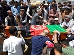 Afghans bury Dawa Khan Menapal, director of Afghanistan’s government information media centre, in Kabul.
