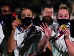 USA athletes show their gold medals during the closing ceremony in the Olympic Stadium at the 2020 Summer Olympics, Sunday, Aug. 8, 2021, in Tokyo, Japan. (AP Photo/Jae C. Hong)