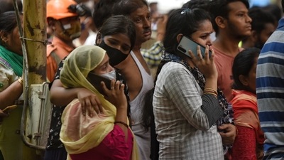 Family members of a person trapped under the debris watch rescue operation take place at Nand Nagri. (Sanchit Khanna/Hindustan Times) Family members of a person trapped under the debris watch rescue operation take place at Nand Nagri. (Sanchit Khanna/Hindustan Times)