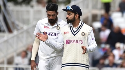 Mohammad Siraj, left, listens to captain Virat Kohli before bowling his next delivery during the fourth day of first test cricket match between England and India, at Trent Bridge in Nottingham. (AP) Mohammad Siraj, left, listens to captain Virat Kohli before bowling his next delivery during the fourth day of first test cricket match between England and India, at Trent Bridge in Nottingham. (AP)