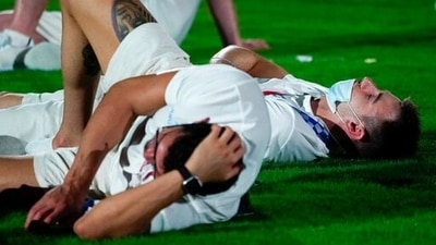 Athletes lie on the field during International Olympic Committee's President Thomas Bach speech during the closing ceremony in the Olympic Stadium at the 2020 Summer Olympics, Sunday, Aug. 8, 2021, in Tokyo, Japan. (AP Photo/Jae C. Hong) (AP)