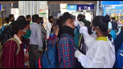 A BMC health worker collects swab samples for Covid-19 test of passengers arriving from outstation trains at CSMT station, in Mumbai, India, on Monday. (HT PHOTO) A BMC health worker collects swab samples for Covid-19 test of passengers arriving from outstation trains at CSMT station, in Mumbai, India, on Monday. (HT PHOTO)