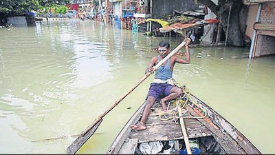 A boatman rows his boat through a waterlogged road after the water level of the Ganga rises due to heavy rainfall, in Prayagraj on Sunday. (ANI Photo) A boatman rows his boat through a waterlogged road after the water level of the Ganga rises due to heavy rainfall, in Prayagraj on Sunday. (ANI Photo)