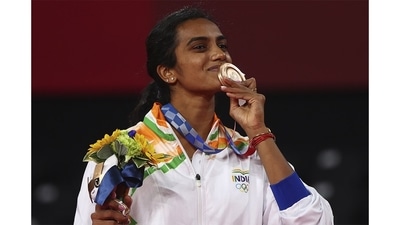 PV Sindhu with her bronze medal during Tokyo 2020 Olympics Badminton women's Singles Medal Ceremony at Musashino Forest Sport Plaza, in Tokyo on August 1. The 26-year-old etched her name among the all-time greats after winning women's singles bronze medal to add to the silver she won at Rio de Janeiro five years back. She became the first Indian woman and second overall from the country to achieve the feat. (Leonhard Foeger / REUTERS) PV Sindhu with her bronze medal during Tokyo 2020 Olympics Badminton women's Singles Medal Ceremony at Musashino Forest Sport Plaza, in Tokyo on August 1. The 26-year-old etched her name among the all-time greats after winning women's singles bronze medal to add to the silver she won at Rio de Janeiro five years back. She became the first Indian woman and second overall from the country to achieve the feat. (Leonhard Foeger / REUTERS)