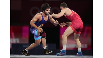 Bajrang Punia competes against Haji Aliyev of Azerbaijan in the semi-finals of men's freestyle 65kg wrestling match at the 2020 Summer Olympics, in Japan, on August 6. A favourite heading into the Games, Bajrang didn't quite live up to the sky-high expectations of becoming the first Indian wrestler to win the gold, but the 27-year-old did return with a bronze medal-- an impressive feat in a nation starved for success at the grandest sporting spectacle. (Gurinder Osan / PTI) Bajrang Punia competes against Haji Aliyev of Azerbaijan in the semi-finals of men's freestyle 65kg wrestling match at the 2020 Summer Olympics, in Japan, on August 6. A favourite heading into the Games, Bajrang didn't quite live up to the sky-high expectations of becoming the first Indian wrestler to win the gold, but the 27-year-old did return with a bronze medal-- an impressive feat in a nation starved for success at the grandest sporting spectacle. (Gurinder Osan / PTI)