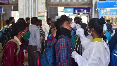 A BMC health worker collects swab samples for Covid-19 test of passengers arriving from outstation trains at CSMT station. (HT PHOTO) A BMC health worker collects swab samples for Covid-19 test of passengers arriving from outstation trains at CSMT station. (HT PHOTO)