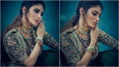 She accessorised her look with a golden choker with green stones and colourful bangles. (Instagram/@imouniroy)