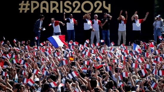 People gather at Paris' Olympics fan zone to watch the closing ceremony of the Tokyo games, in front of the Eiffel Tower, at Trocadero Gardens in Paris, France, August 8, 2021. REUTERS/Benoit Tessier(REUTERS)