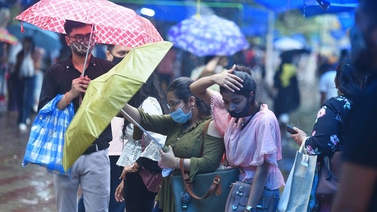 Youngsters get caught in the rain while shopping at Janpath market, New Delhi on August 8.(Raj K Raj/Hindustan Times)
