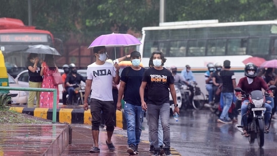 Commuters seen amid light rains at Janpath Road, in New Delhi on August 8. (Raj K Raj/Hindustan Times)