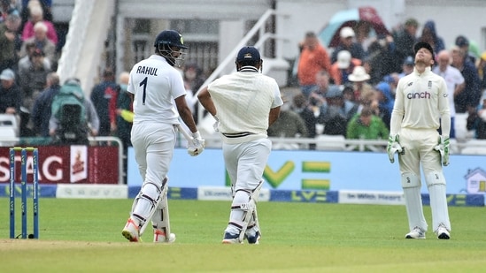 England wicketkeeper Jos Buttler, right, reacts as Indian batsmen KL Rahul, left, and Rishabh Pant walk off the field after rain stopped play during the third day of first test cricket match between England and India.(AP)