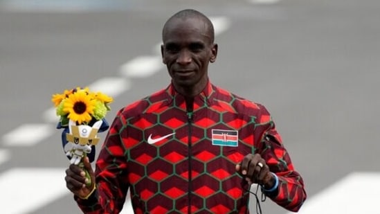 Gold medalist Eliud Kipchoge, of Kenya, poses during the flower ceremony for men's marathon at the 2020 Summer Olympics.(AP)