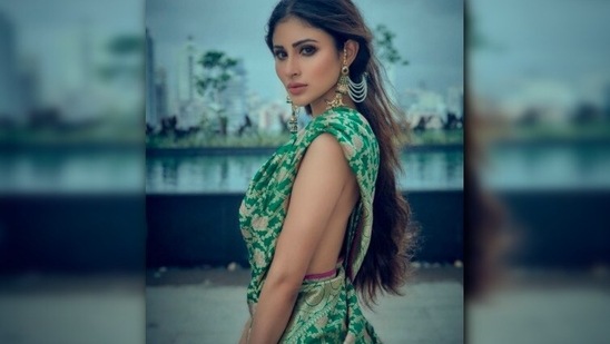 In another still, Mouni can be seen draping a green and golden Banarasi saree in Bengali style. Sharing the picture on Instagram, she captioned it, "Kajol aar gaal bhora bhalobasha. #ThatBengaliSareeGirlForever."(Instagram/@imouniroy)