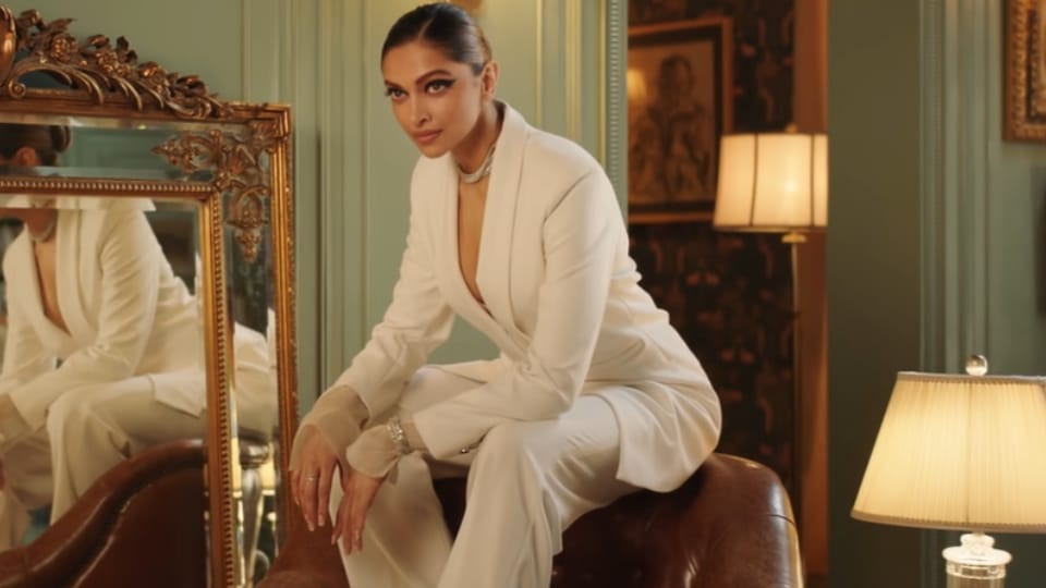 Deepika wore an all-white blazer and pants. (YouTube/asianpaints) Deepika wore an all-white blazer and pants. (YouTube/asianpaints)